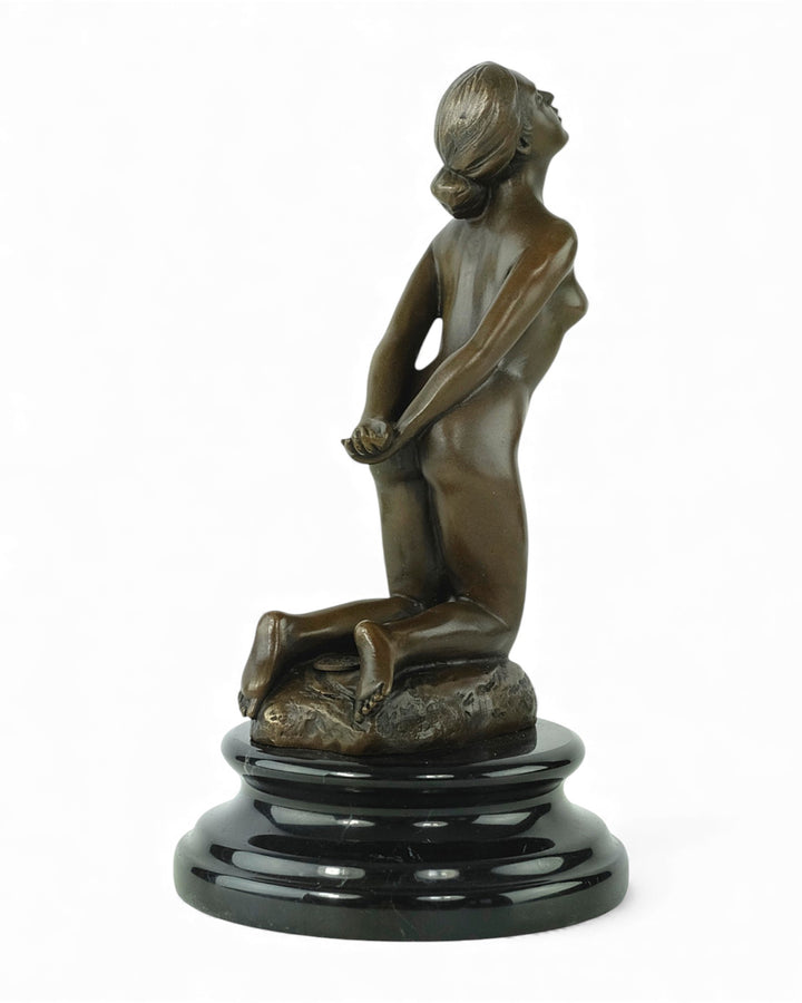 Bronze sculpture of a submissive kneeling female nude
