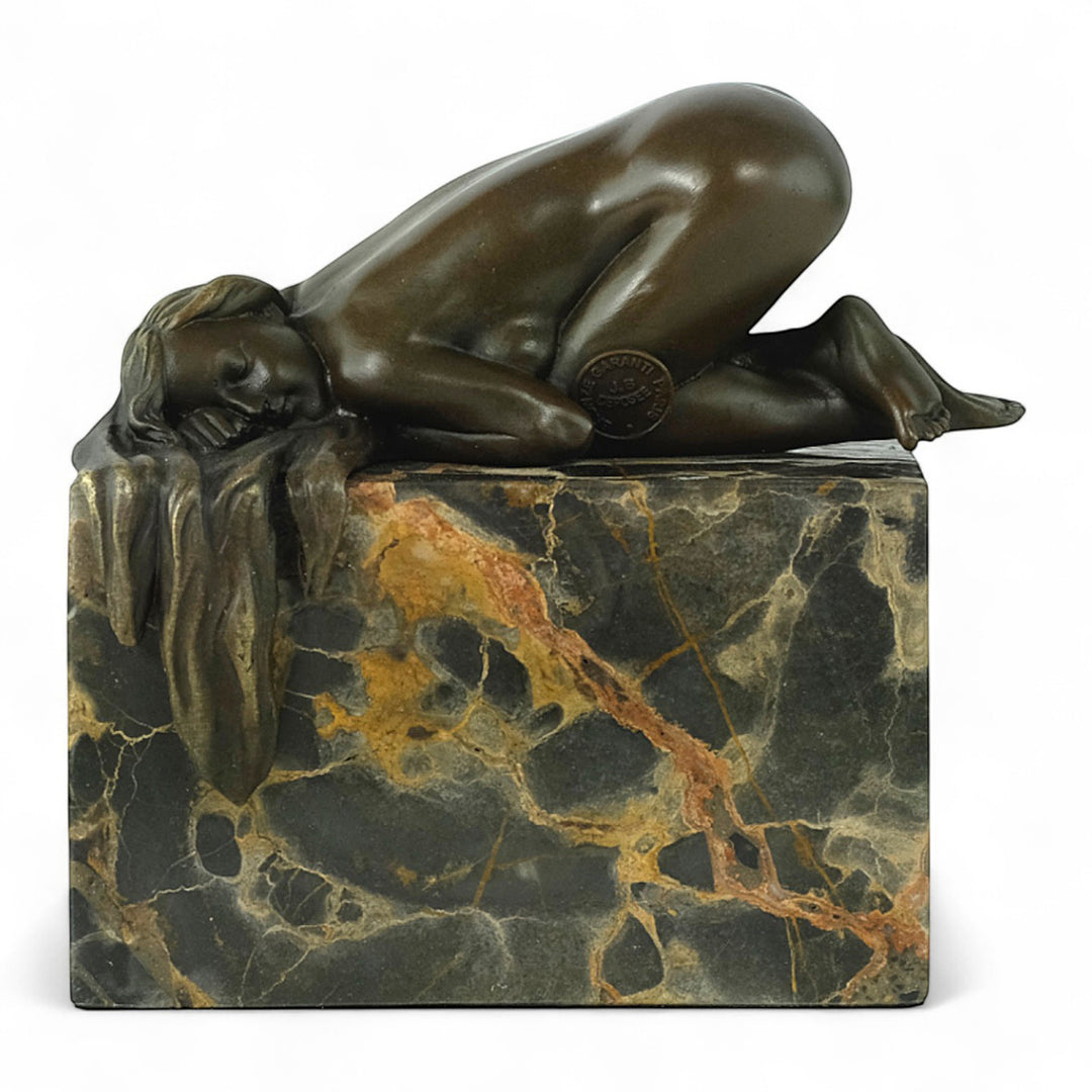 Bronze sculpture of a sensual resting female