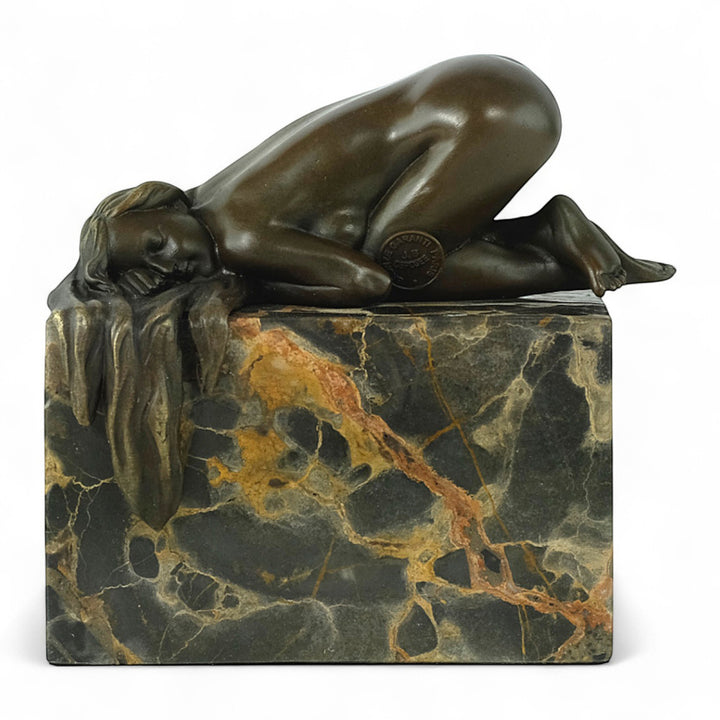 Bronze sculpture of a sensual resting female