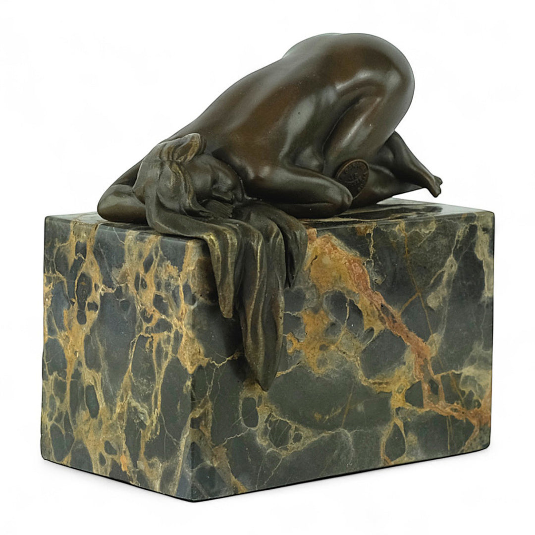 Bronze sculpture of a sensual resting female