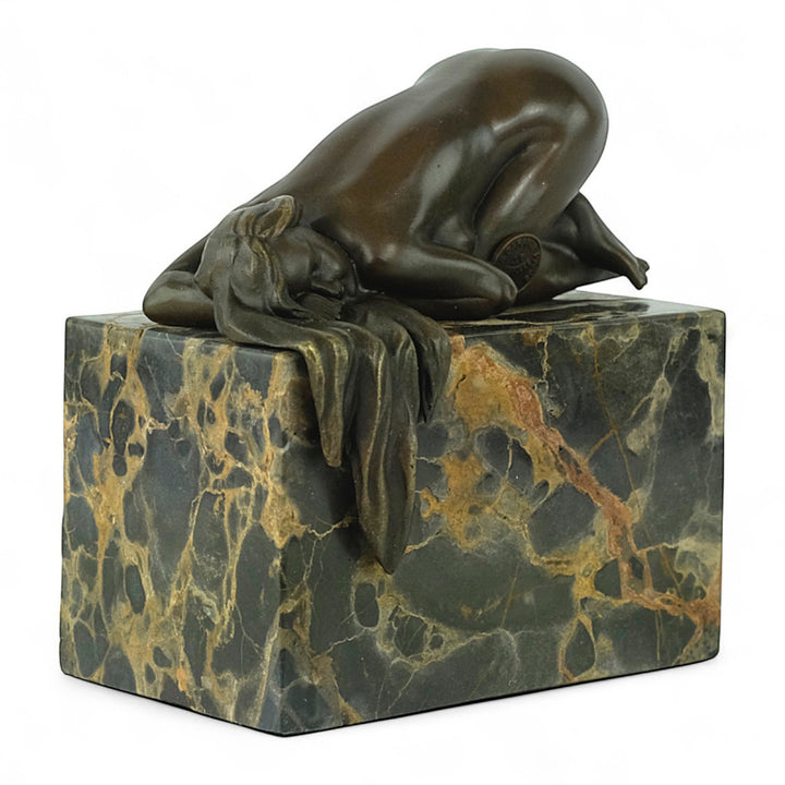 Bronze sculpture of a sensual resting female