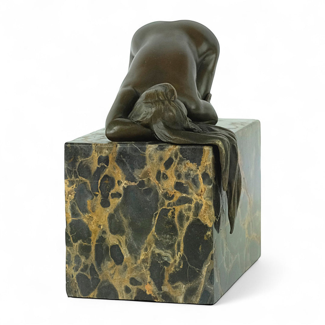Bronze sculpture of a sensual resting female
