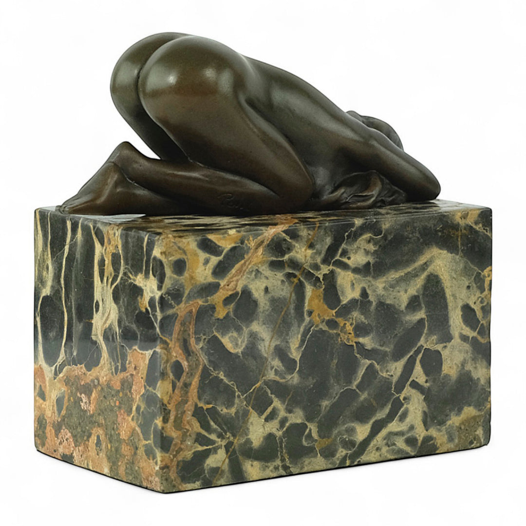 Bronze sculpture of a sensual resting female