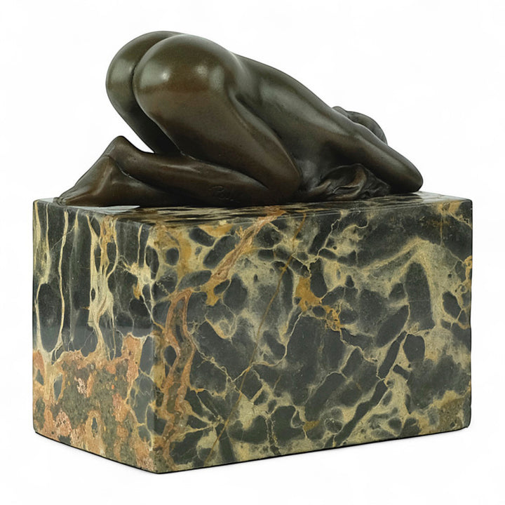 Bronze sculpture of a sensual resting female