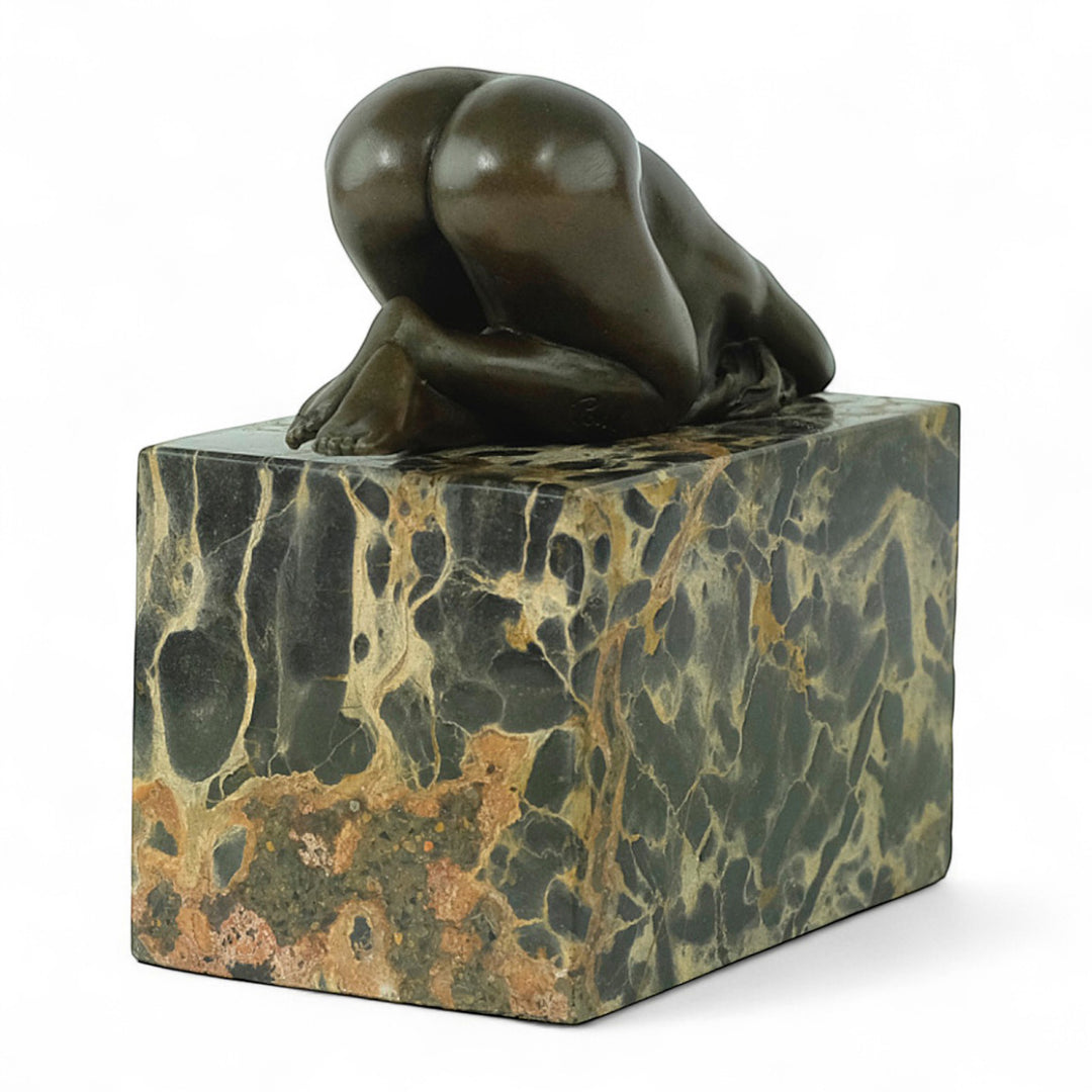 Bronze sculpture of a sensual resting female