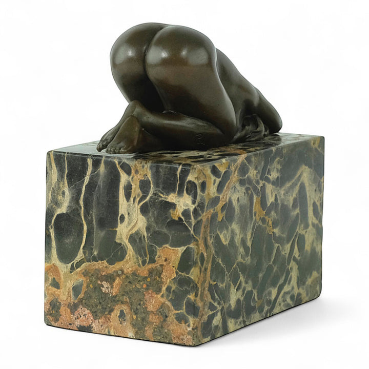 Bronze sculpture of a sensual resting female