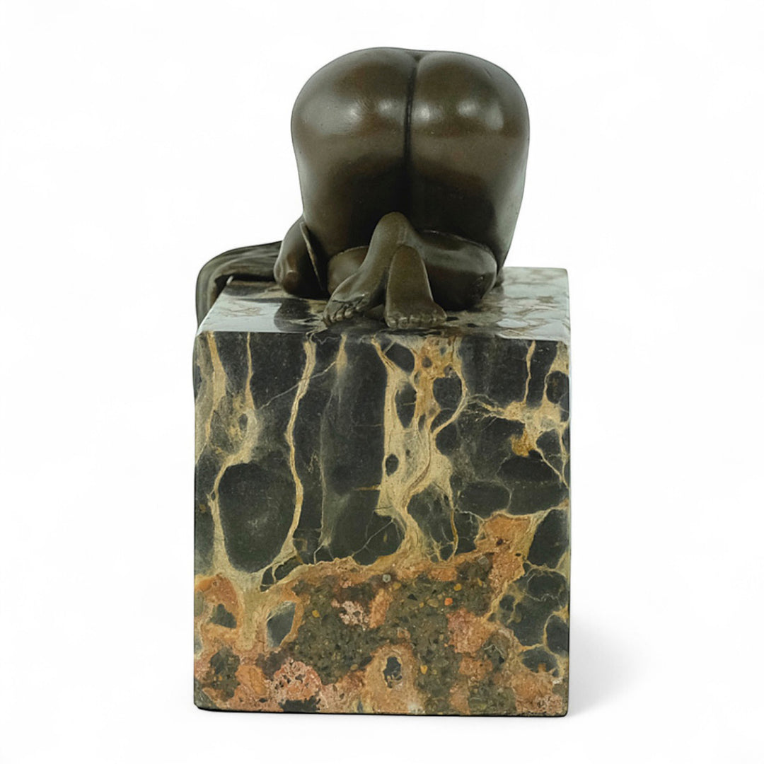 Bronze sculpture of a sensual resting female