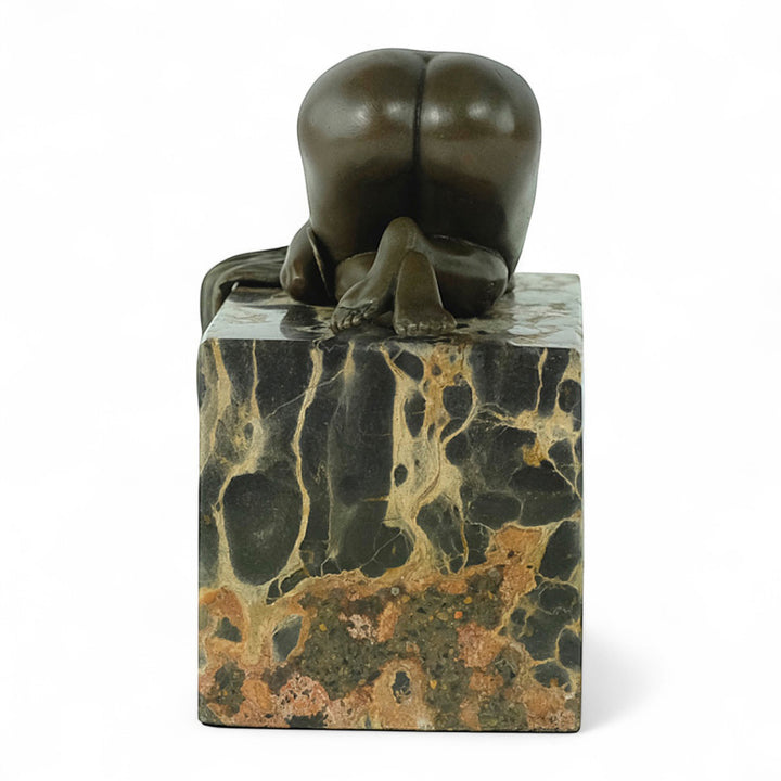 Bronze sculpture of a sensual resting female