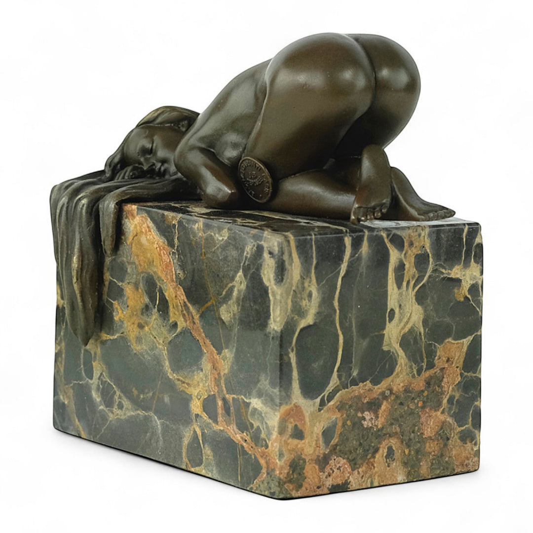 Bronze sculpture of a sensual resting female