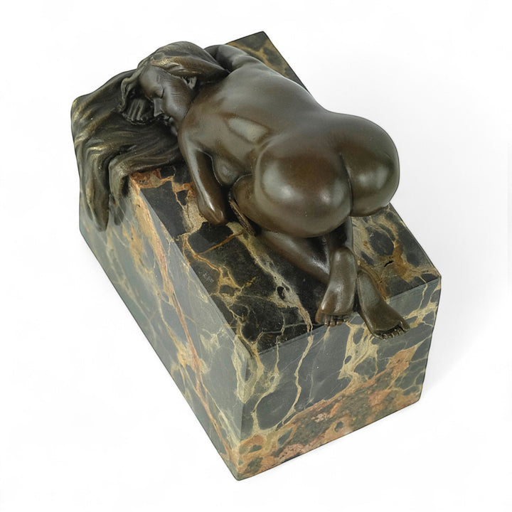 Bronze sculpture of a sensual resting female