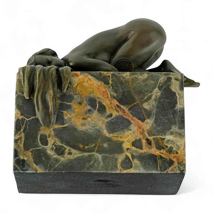 Bronze sculpture of a sensual resting female