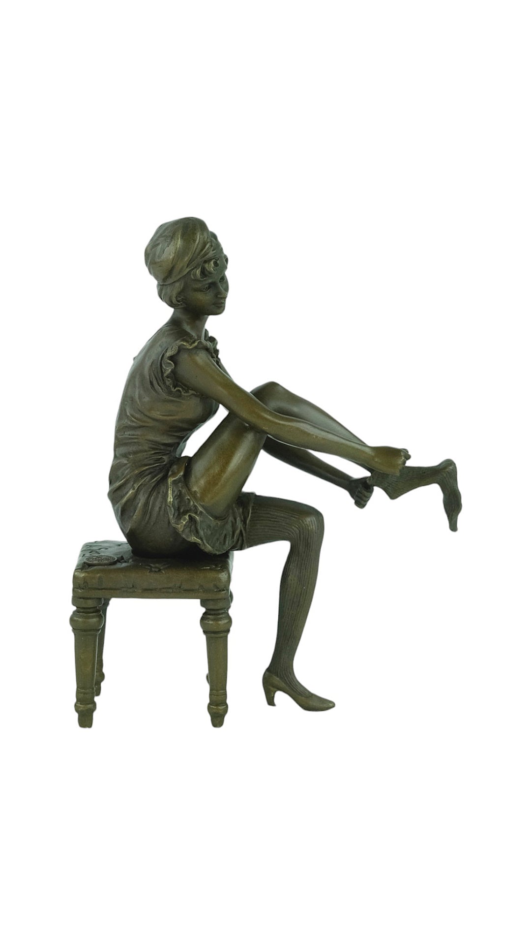 Bronze sculpture of a sitting female putting on stockings