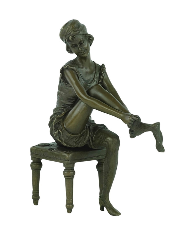 Bronze sculpture of a sitting female putting on stockings