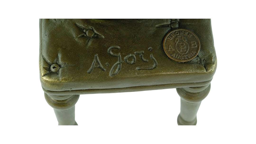 Bronze sculpture of a sitting female putting on stockings
