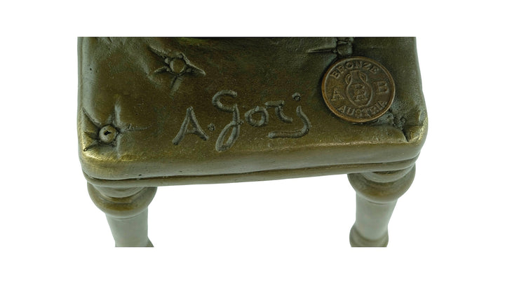 Bronze sculpture of a sitting female putting on stockings