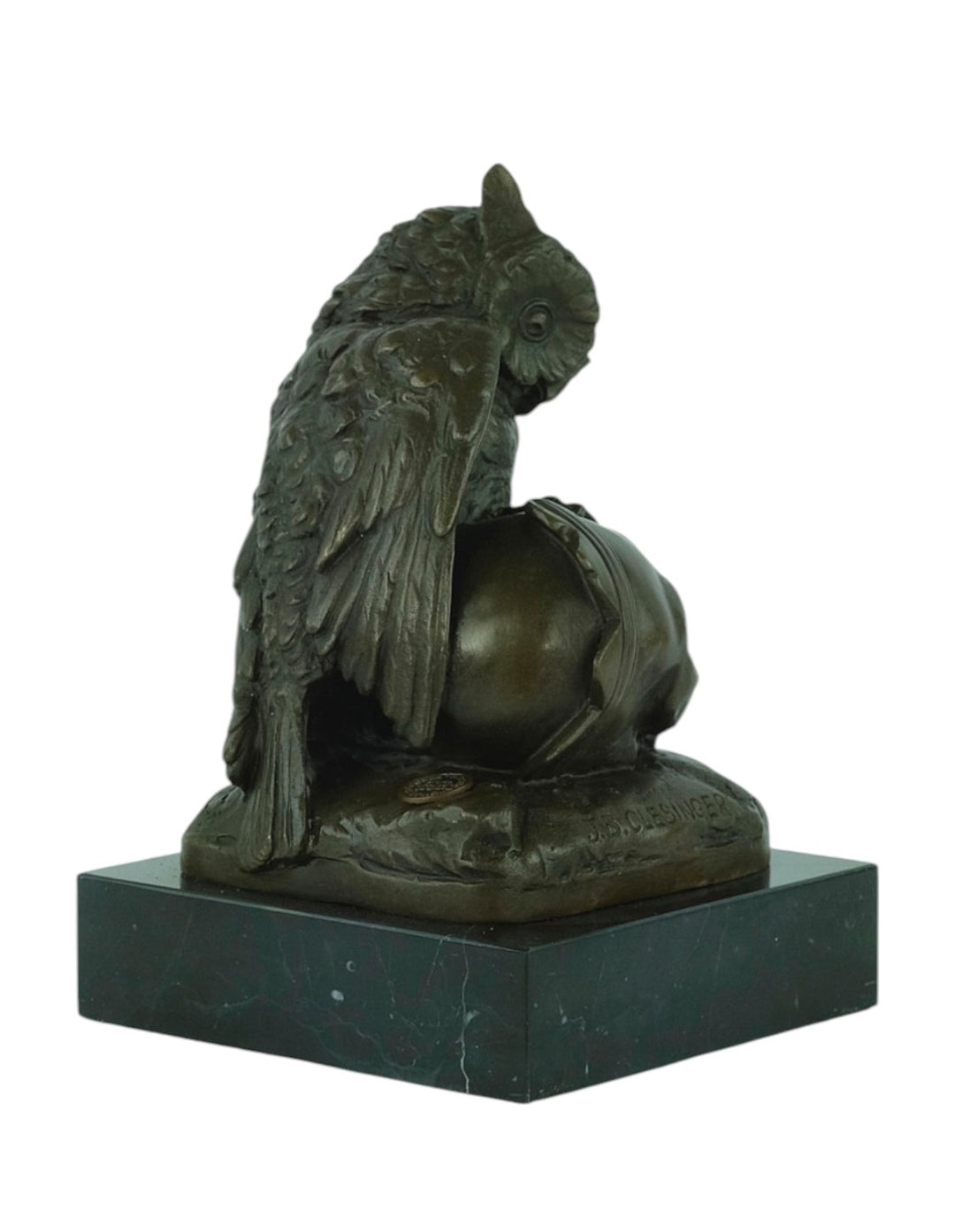 Bronze sculpture of an owl sitting next to a crowned skull