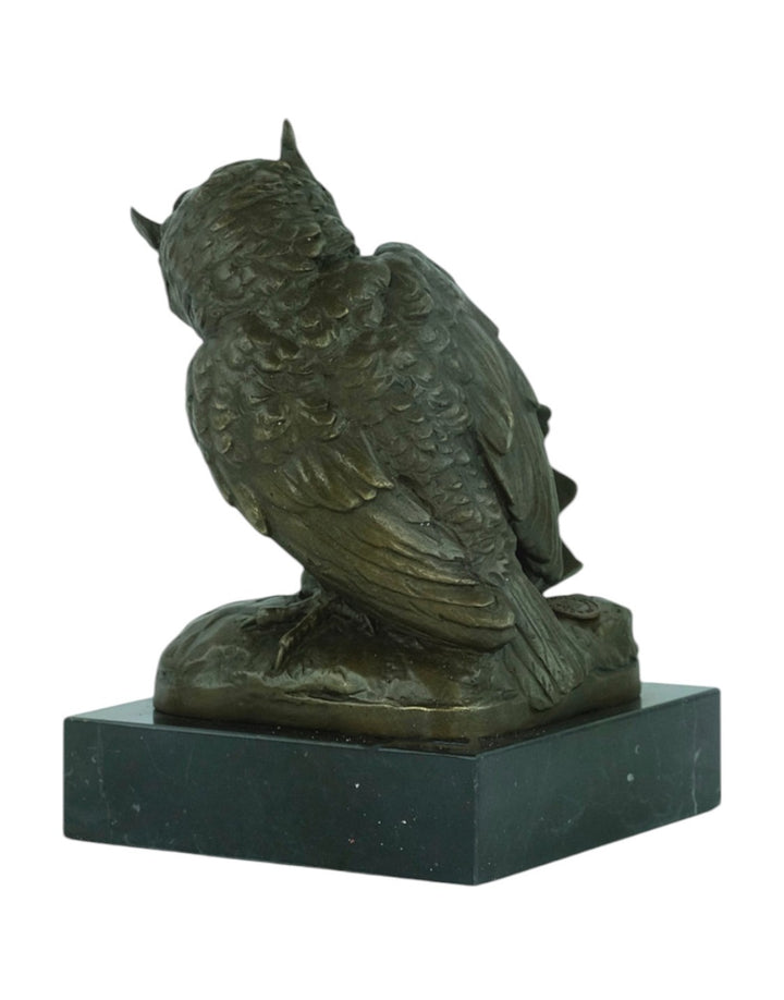 Bronze sculpture of an owl sitting next to a crowned skull