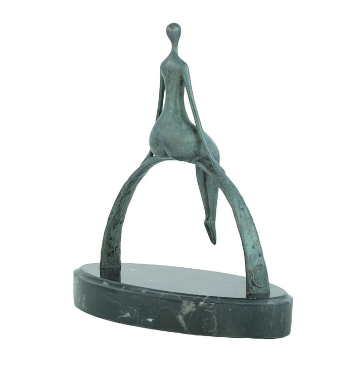 Modern bronze sculpture of a female sitting on a bow