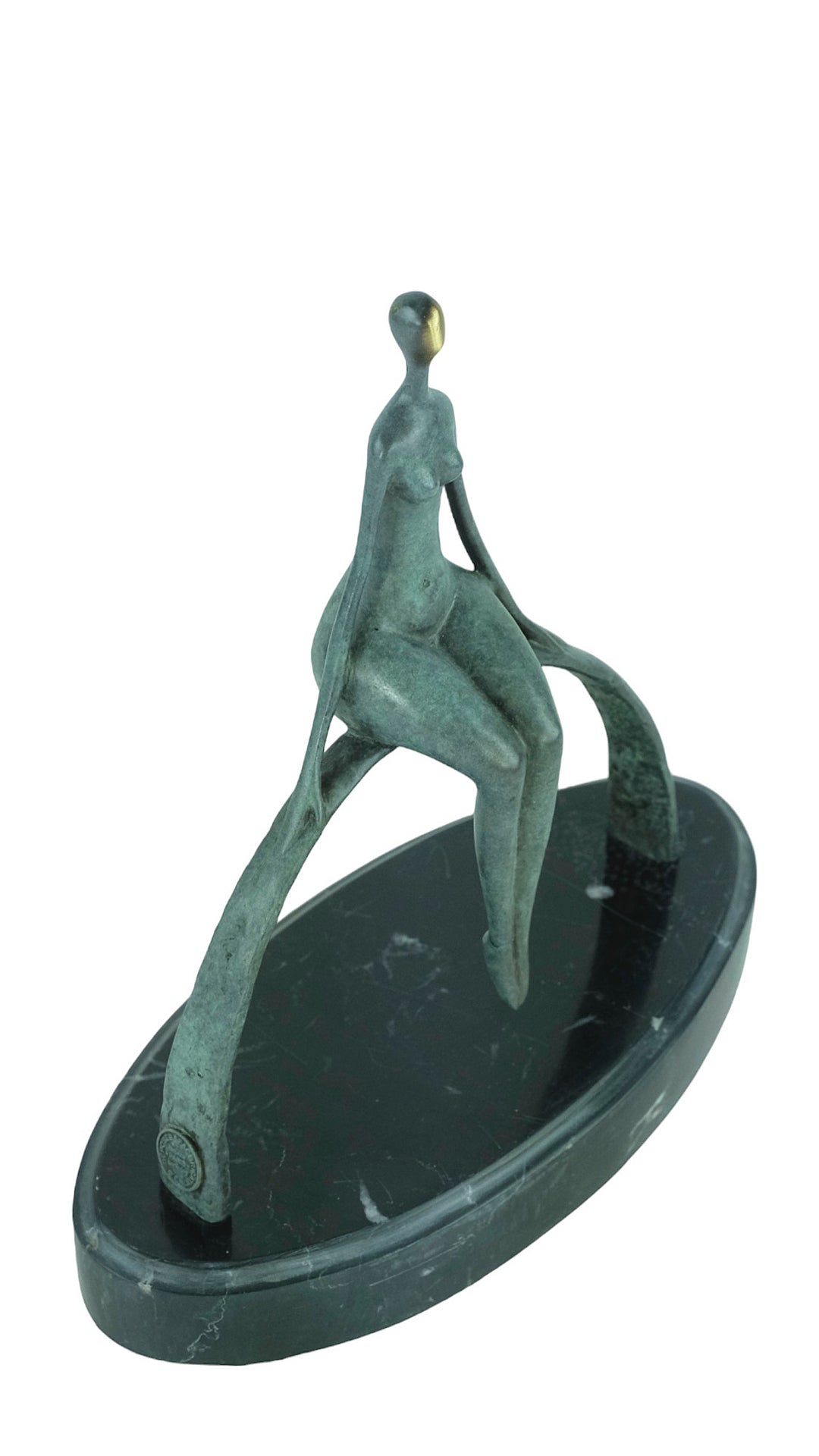 Modern bronze sculpture of a female sitting on a bow