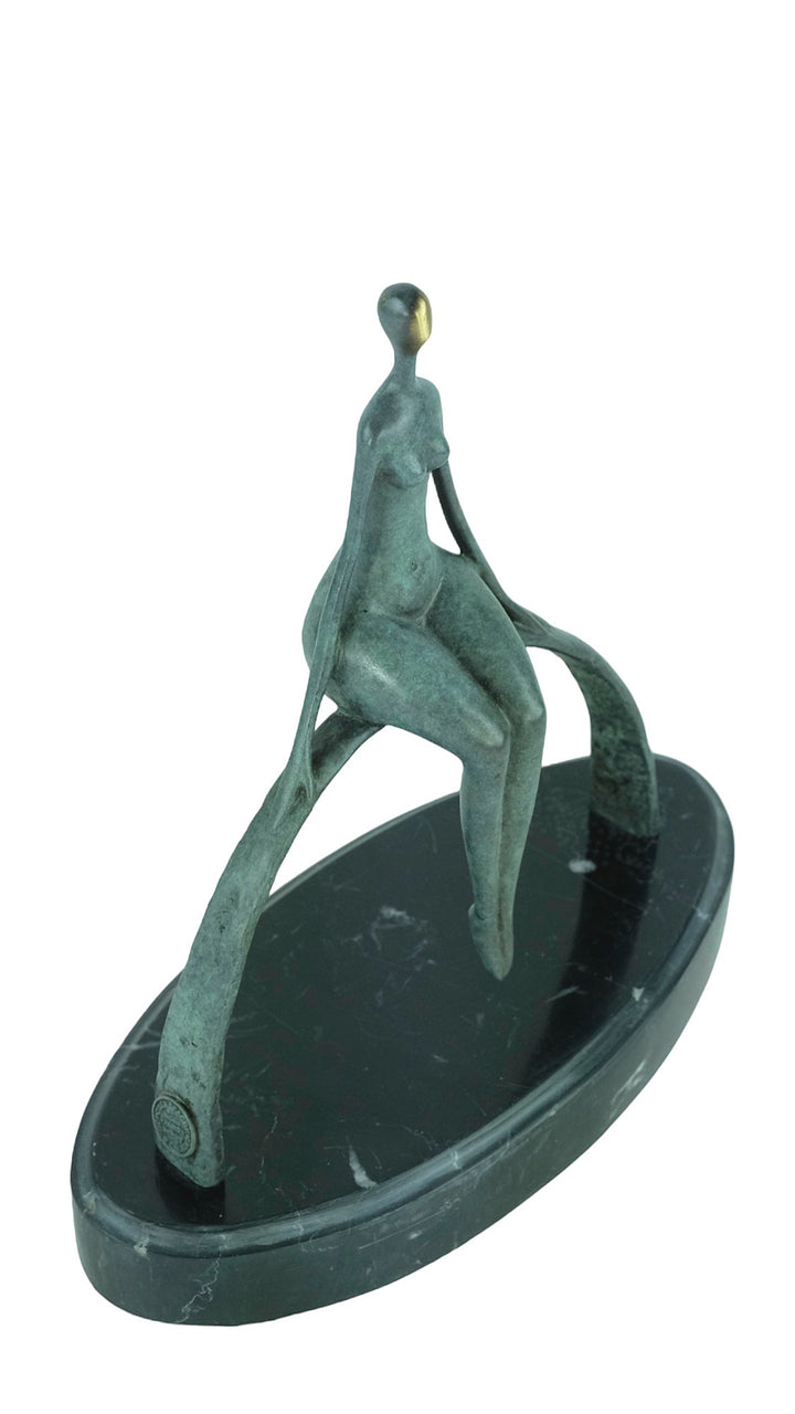 Modern bronze sculpture of a female sitting on a bow