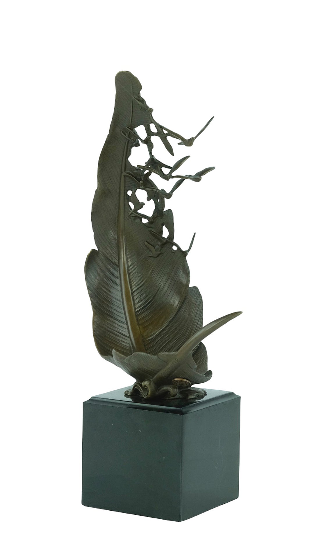 Bronze sculpture of doves flying out of a feather