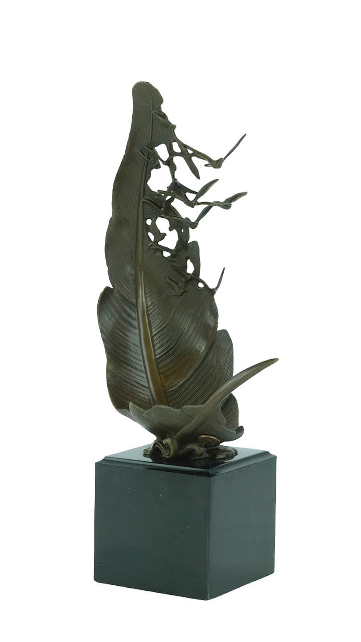 Bronze sculpture of doves flying out of a feather