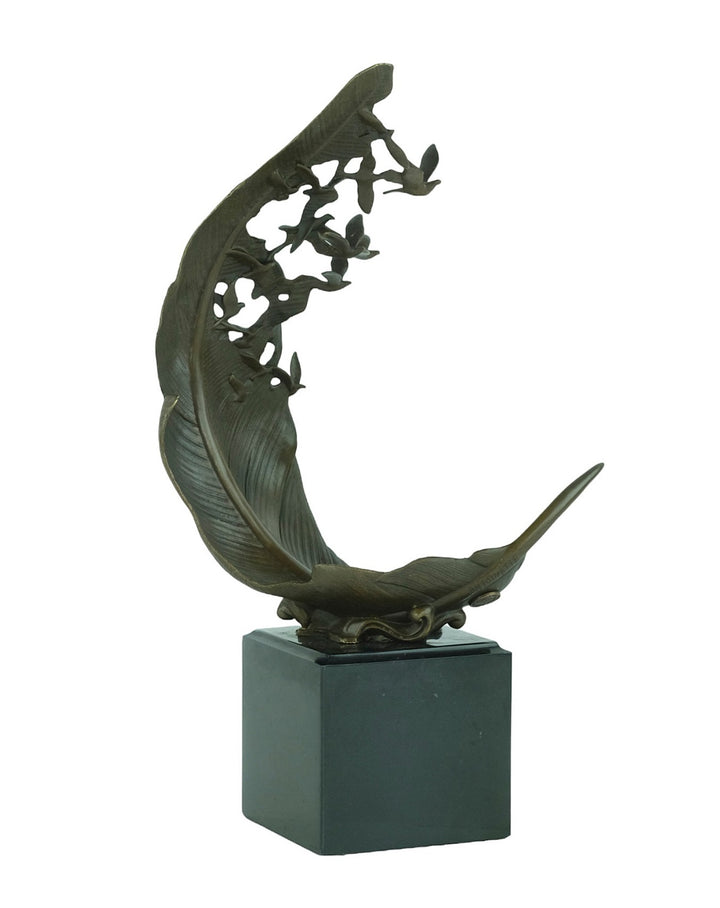 Bronze sculpture of doves flying out of a feather