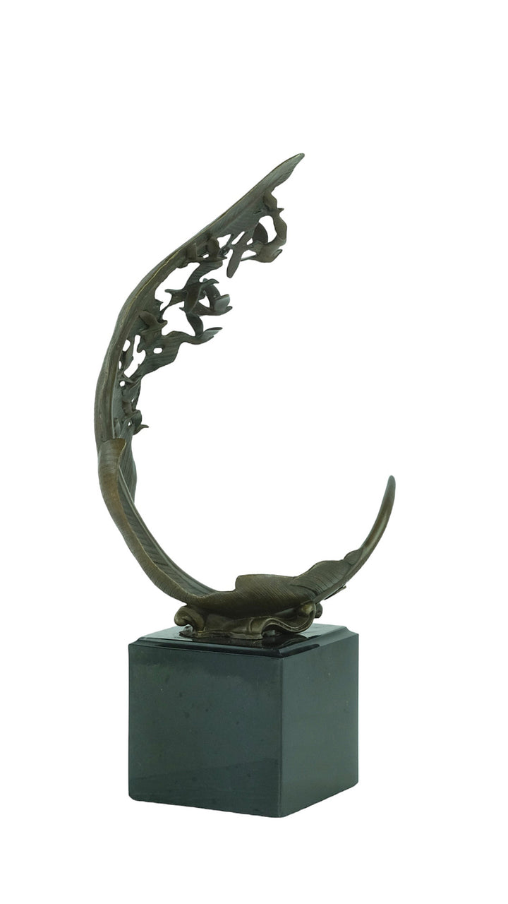 Bronze sculpture of doves flying out of a feather