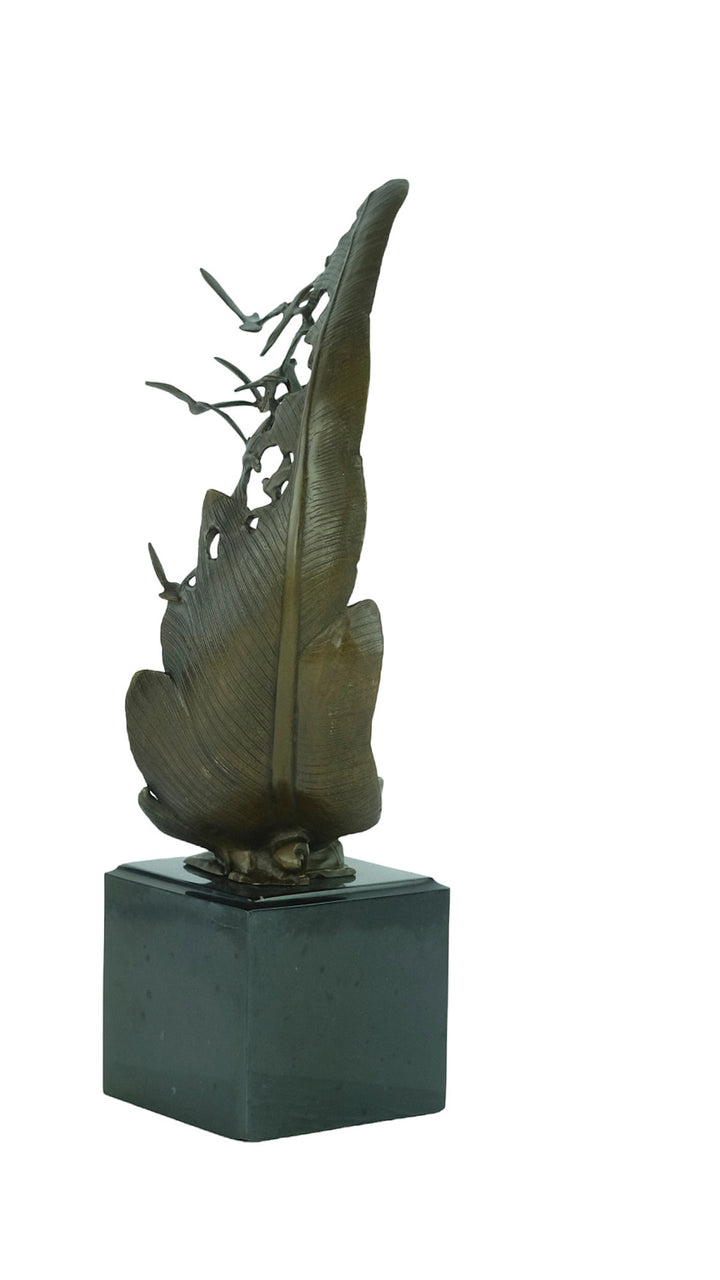 Bronze sculpture of doves flying out of a feather