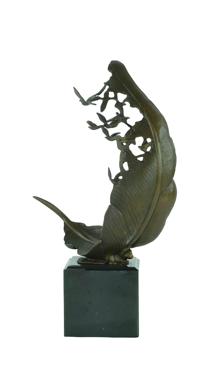 Bronze sculpture of doves flying out of a feather