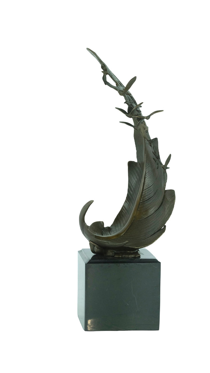 Bronze sculpture of doves flying out of a feather
