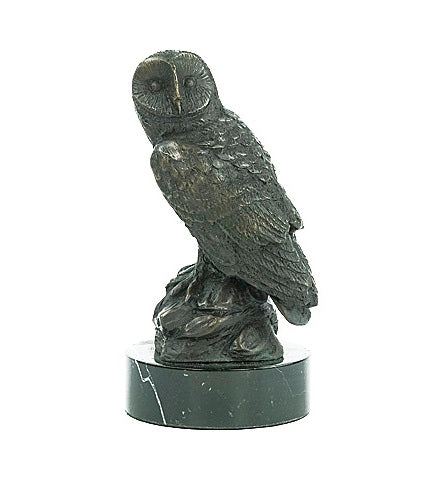 Bronze sculpture of an owl standing on a rock