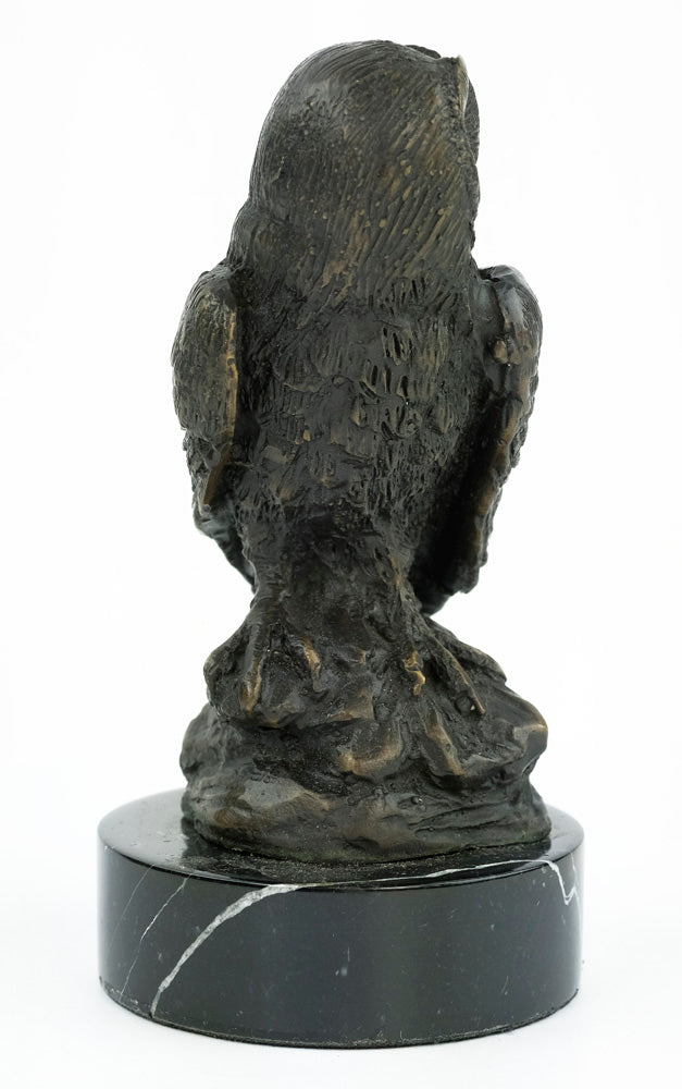 Bronze sculpture of an owl standing on a rock