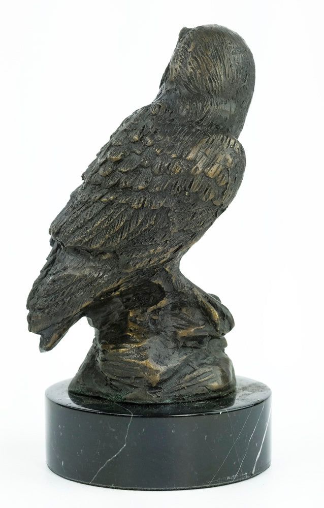 Bronze sculpture of an owl standing on a rock