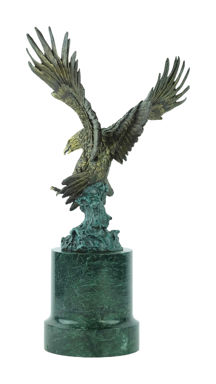 Large bronze sculpture of a fishing eagle with wings spread