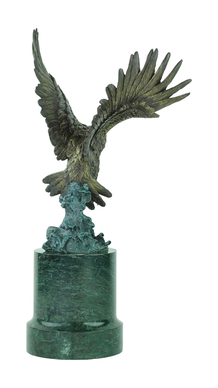Large bronze sculpture of a fishing eagle with wings spread