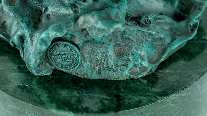 Large bronze sculpture of a fishing eagle with wings spread