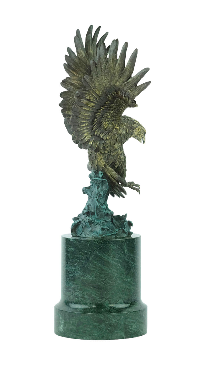 Large bronze sculpture of a fishing eagle with wings spread