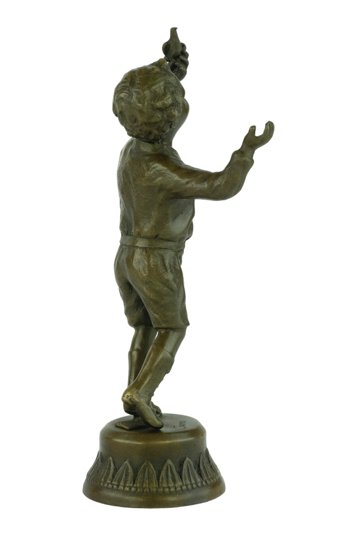 Bronze sculpture of a young boy fascinated by a bird
