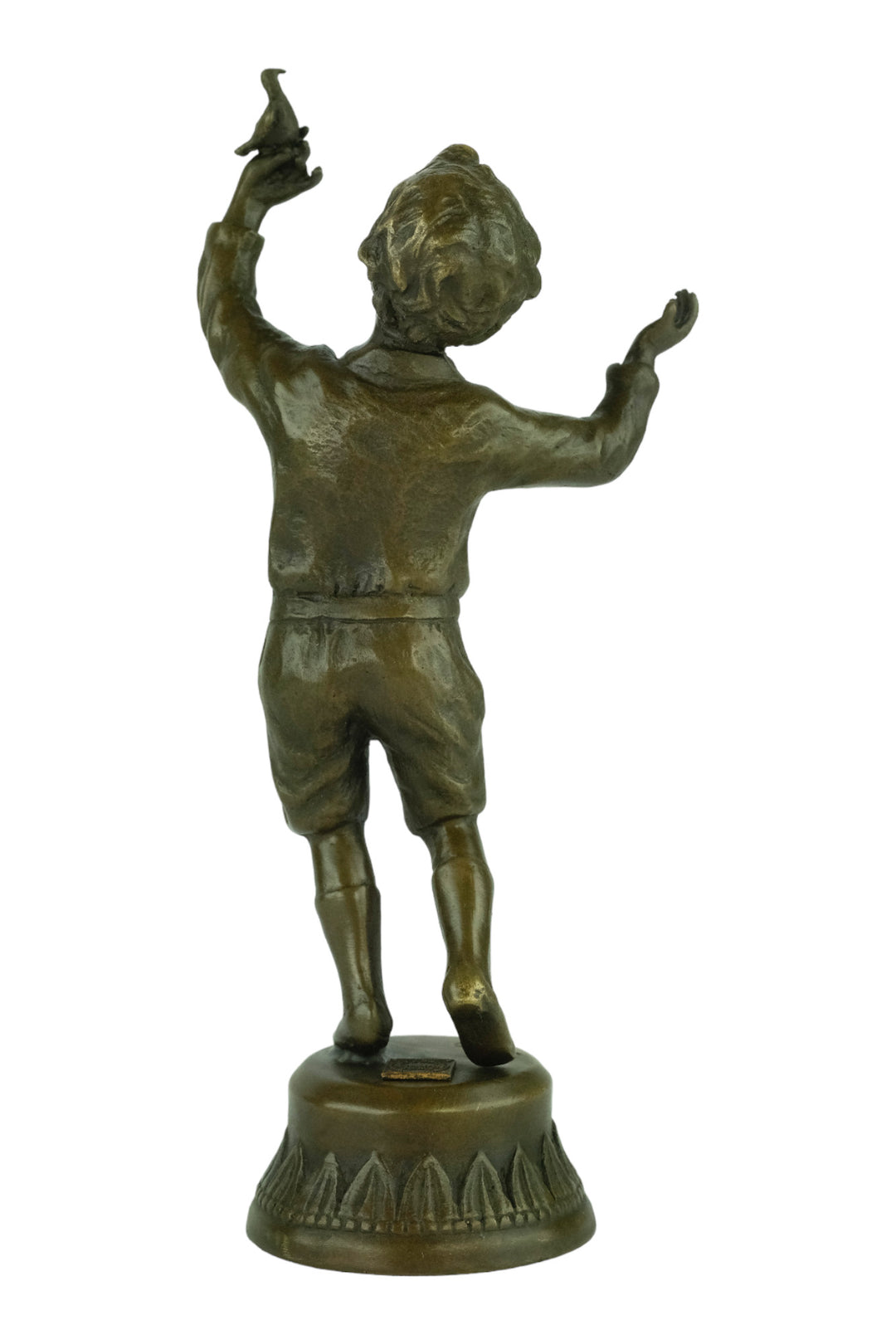 Bronze sculpture of a young boy fascinated by a bird