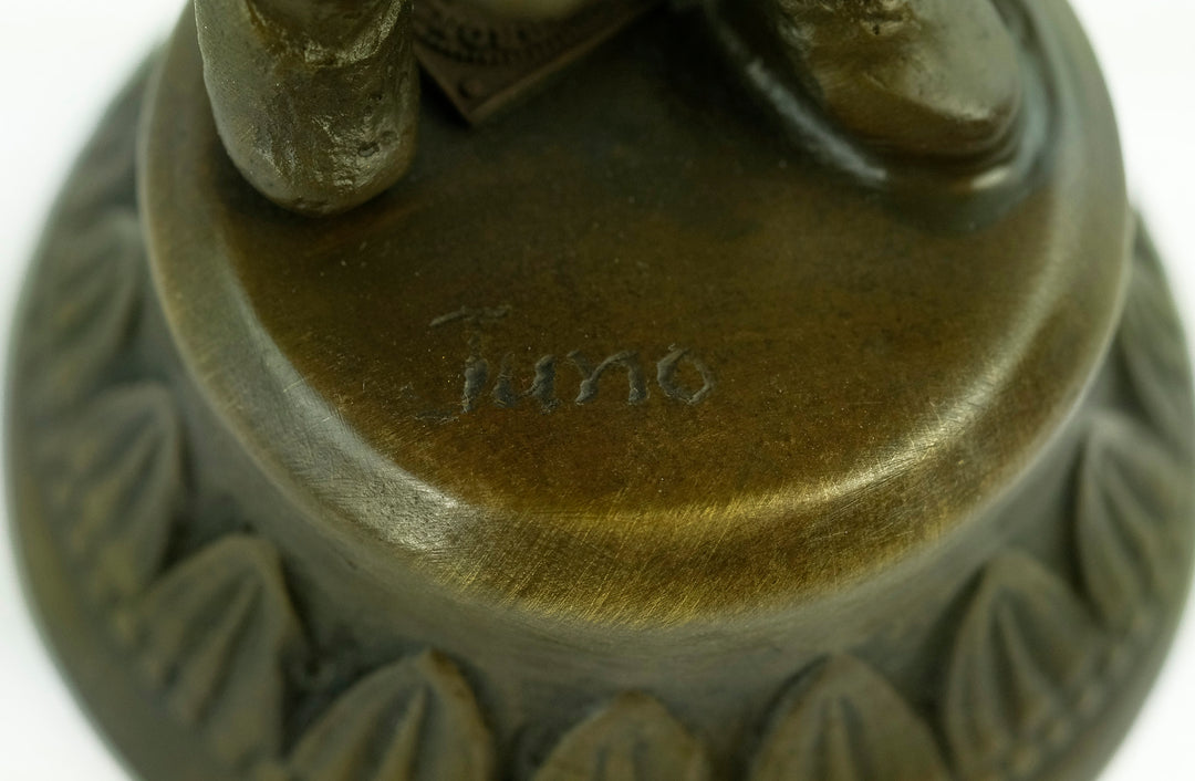 Bronze sculpture of a young boy fascinated by a bird