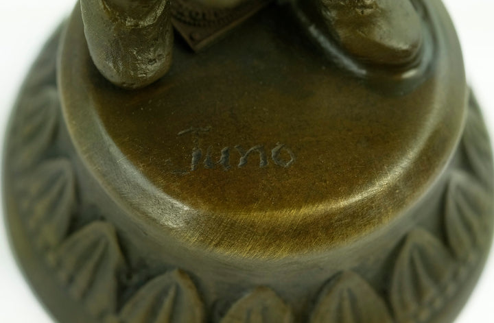 Bronze sculpture of a young boy fascinated by a bird
