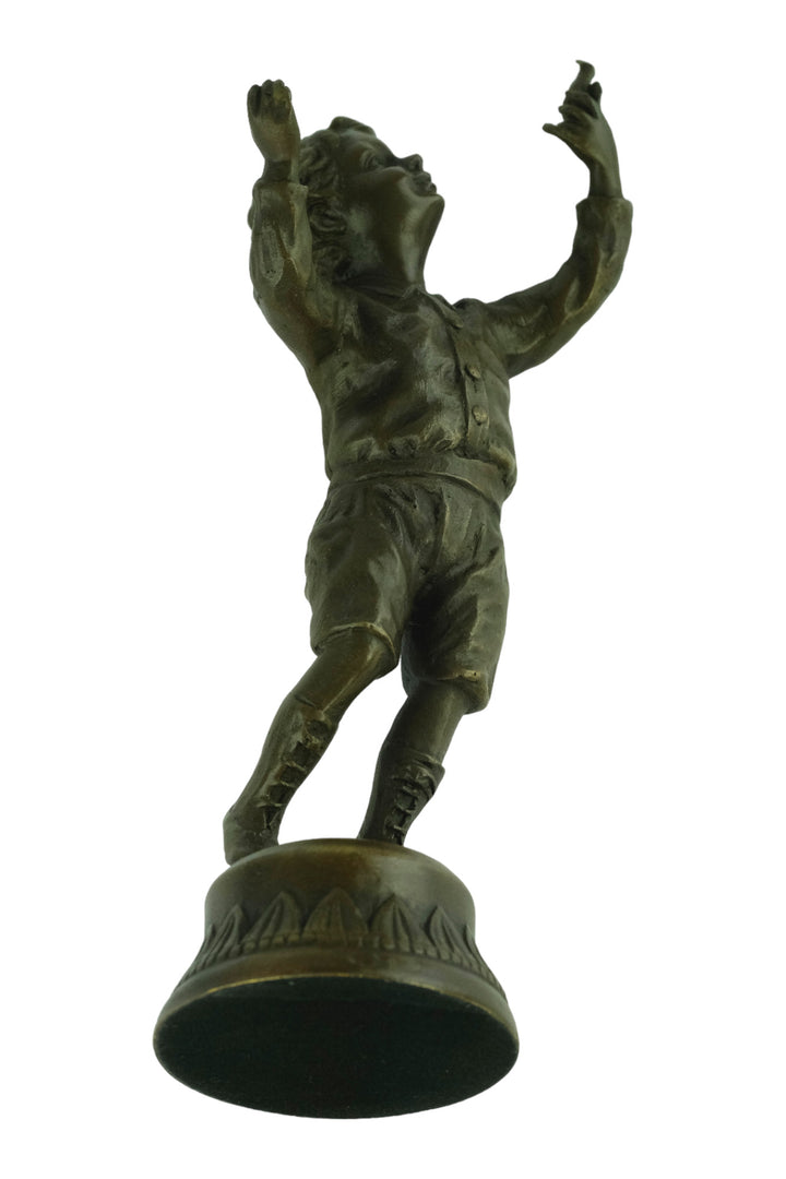 Bronze sculpture of a young boy fascinated by a bird