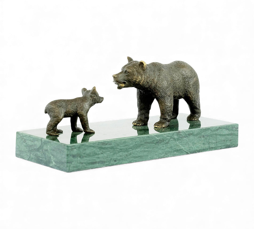 Escultura de bronce de una osa grizzly alimentando a su osezno
