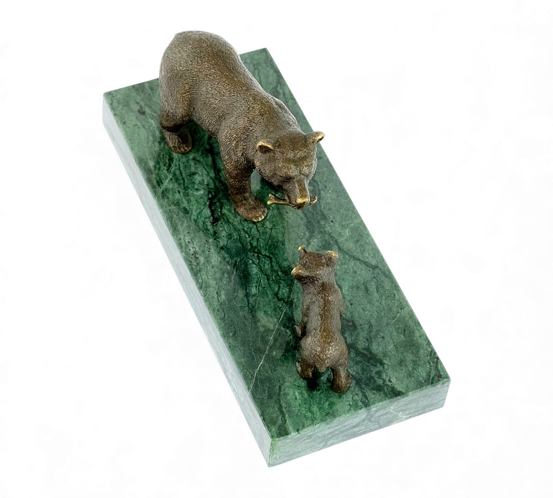 Escultura de bronce de una osa grizzly alimentando a su osezno