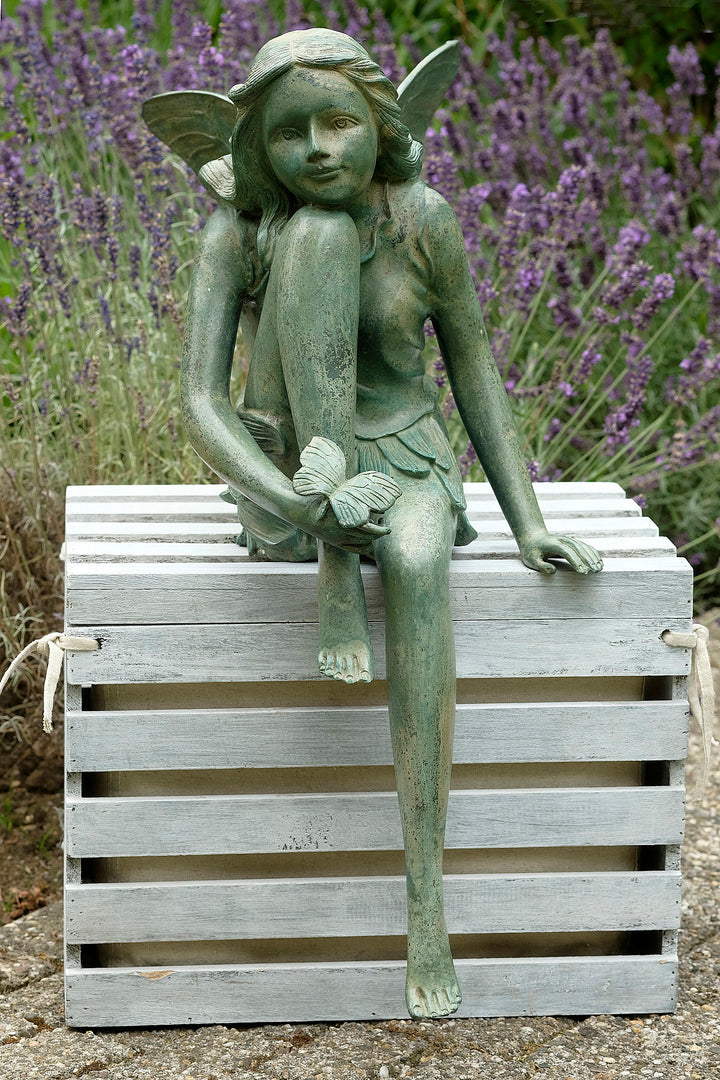 Bronze sculpture of a winged fairy with a butterfly - green patina