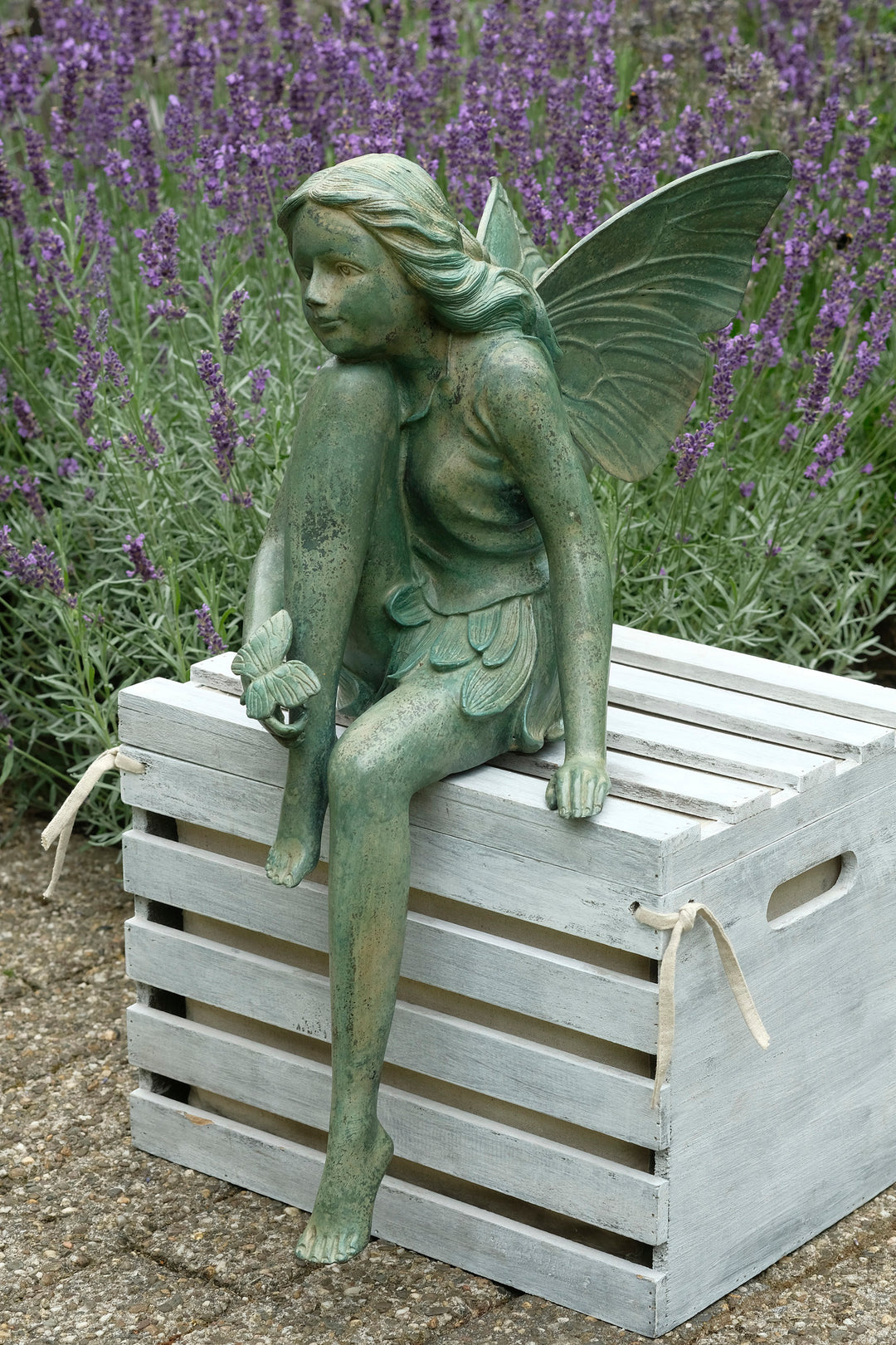 Bronze sculpture of a winged fairy with a butterfly - green patina