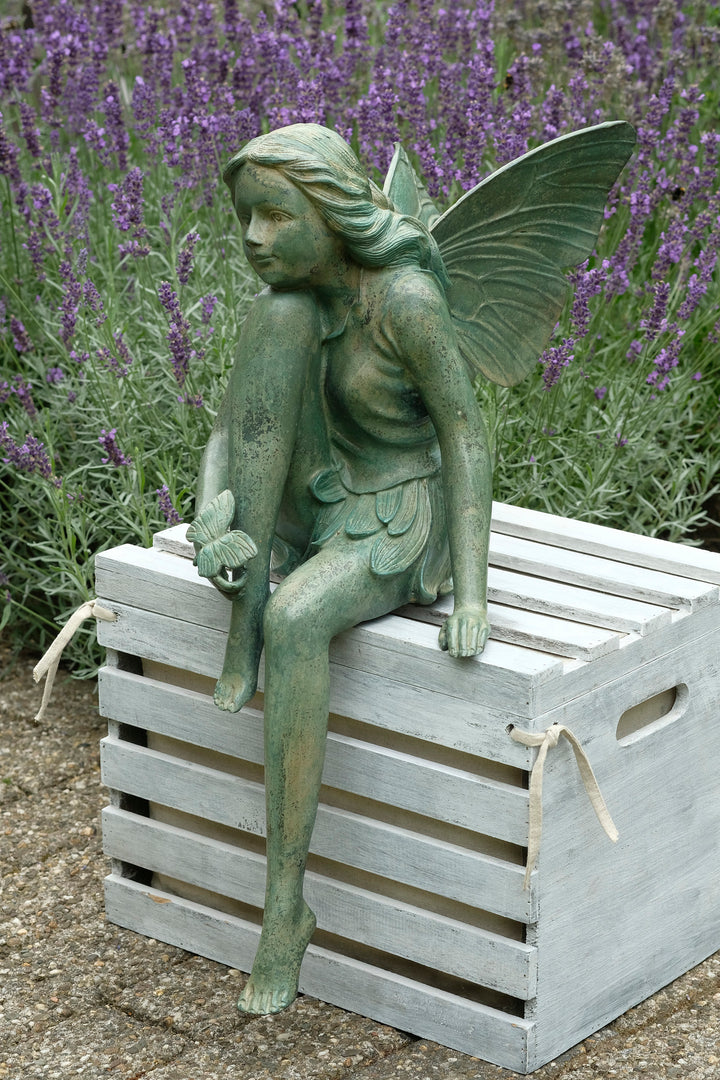 Bronze sculpture of a winged fairy with a butterfly - green patina