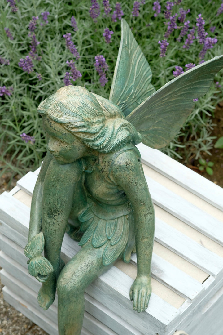 Bronze sculpture of a winged fairy with a butterfly - green patina