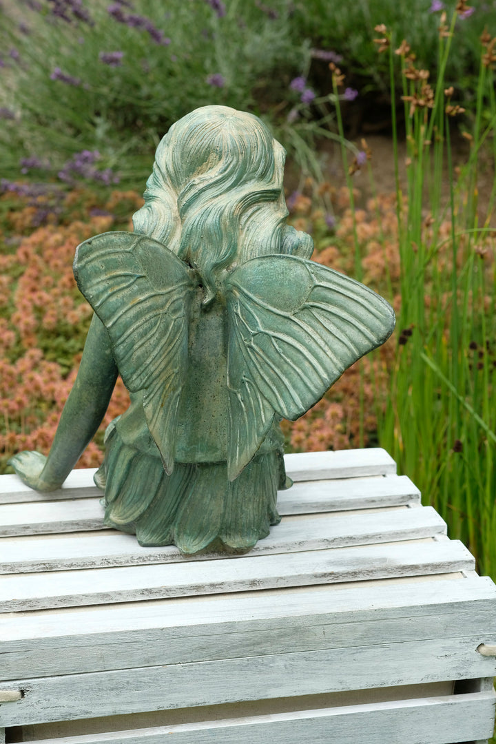 Bronze sculpture of a winged fairy with a butterfly - green patina